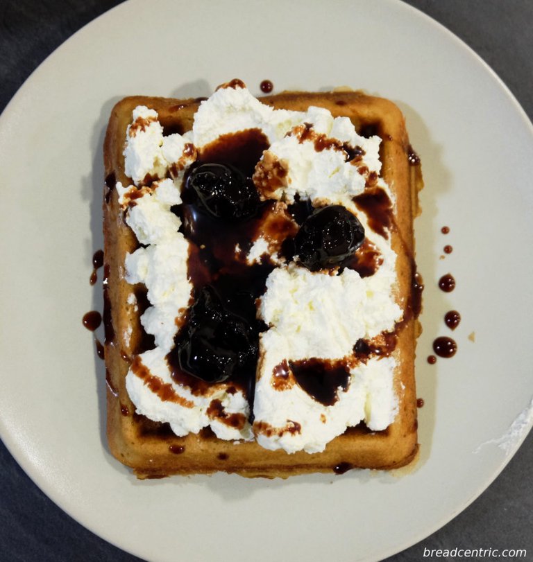 Waffle with whiped cream and Mascarpone cheese, topped with home made sour cherries preserve