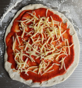 Pizza with tomato sauce and cheese